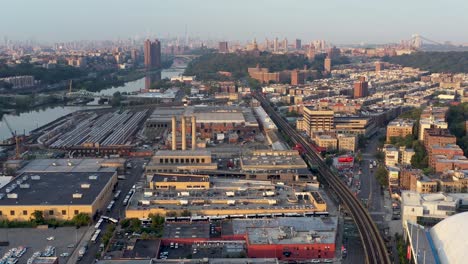 aerial flight over industrial part of inwood upper manhatta towards midtown at golden hour