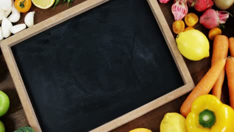 zoom on chalkboard surrounded with fresh vegetables and fruits