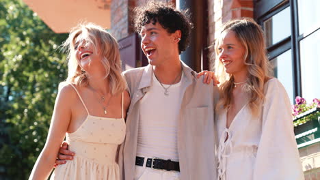 three friends laughing outdoors