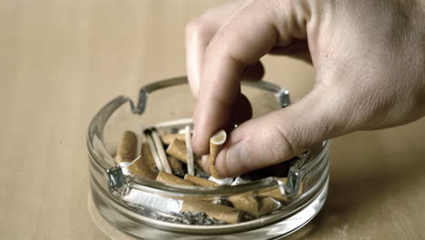 Man putting out cigarette in ashtray