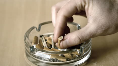 man putting out cigarette in ashtray