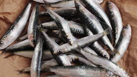 fresh sardines on brown paper