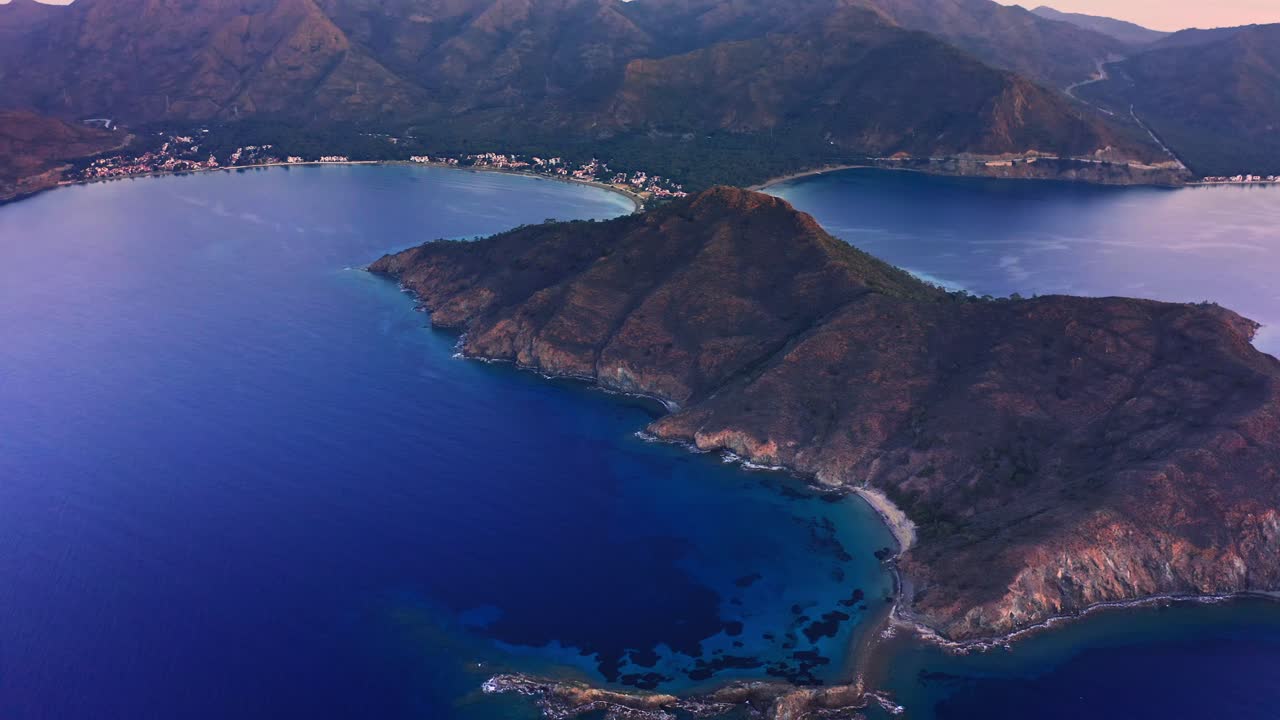 Aerial view of calm Mediterranean seascape among mountainous coastline of Datça peninsula at dawn