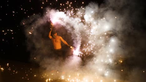 performer displays fire skills amidst sparks and smoke