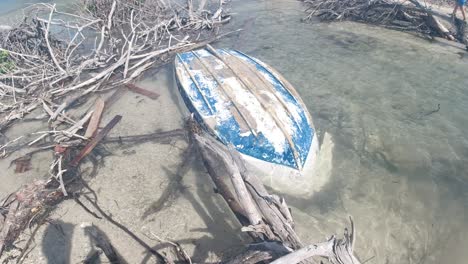 a lost dinghy washed ashore and abandoned on jost van dyke, on the way to bubbly pool in the british virgin islands