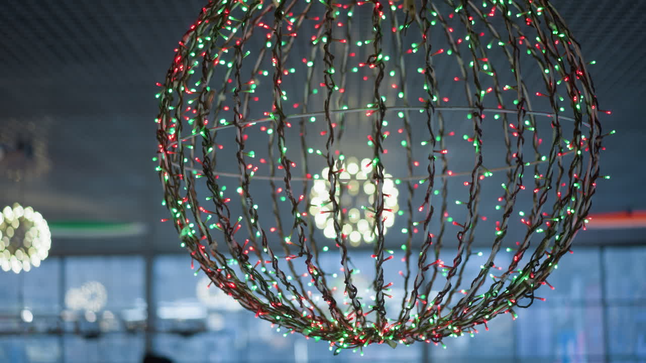 una vista de cerca de una decoración de luz esférica adornada con luces rojas y verdes, creando una atmósfera festiva y colorida