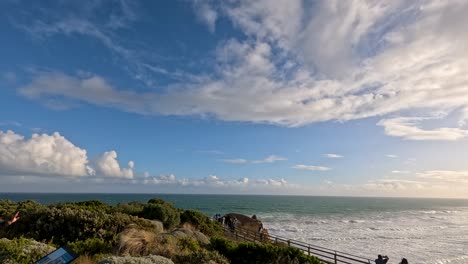 tourists enjoy sunset views over ocean cliffs