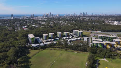 modern exterior of the gold coast university hospital with the cityscape on the background in queensland, australia