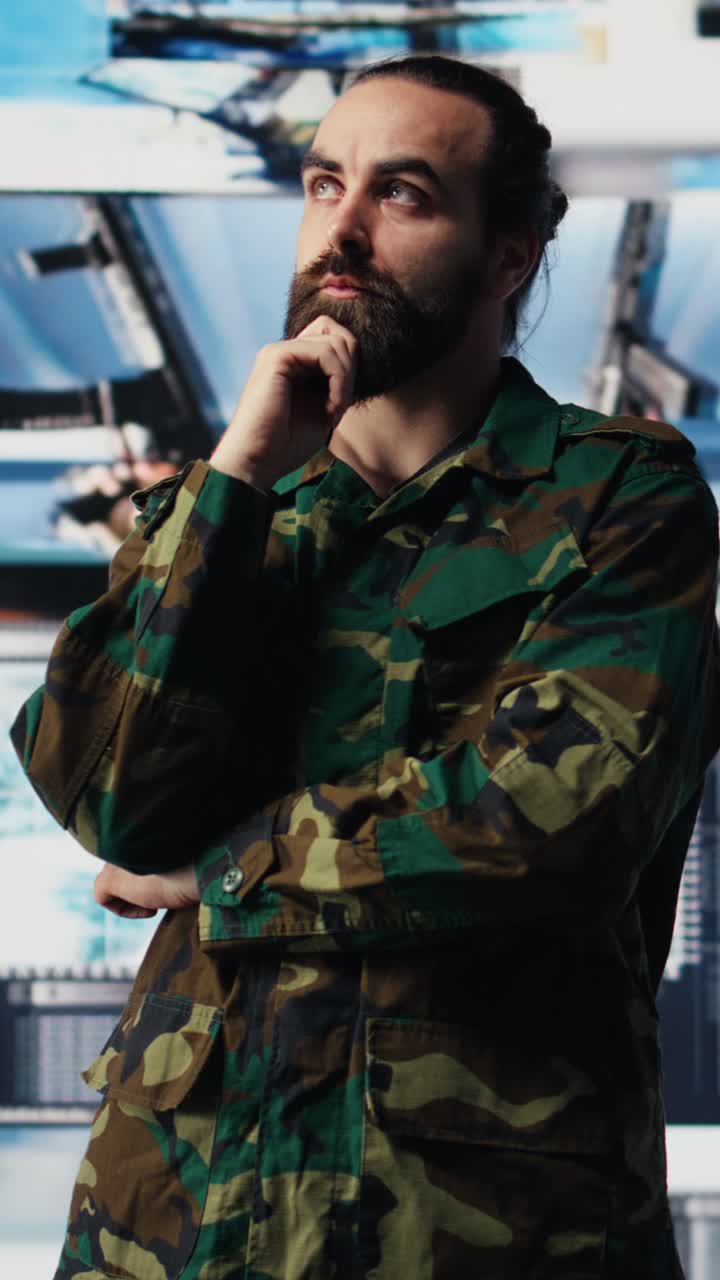 Vertical Video Male army officer operates from a mission command center with digital tech