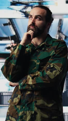 vertical video male army officer operates from a mission command center with digital tech