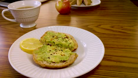 delicious avocado toast with a side of tea and apple