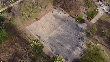 orbit shot of people performing on skate boards out in skate park