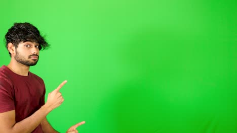 Indian-guy-point-out-with-green-background-indian-guy-standing-on-green-screen---chroma-key