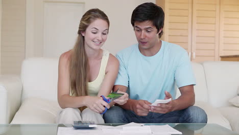 a woman cutting her credit card