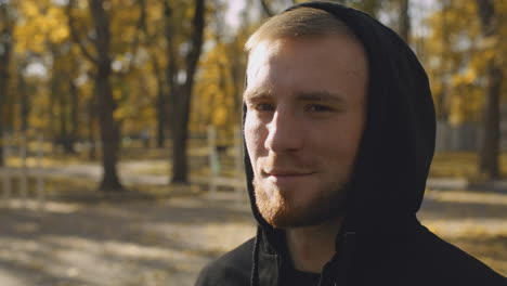 man in a hoodie in an autumn park