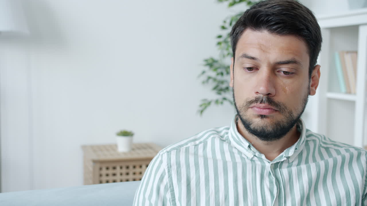 Man Sitting on a Sofa Looking Pensive