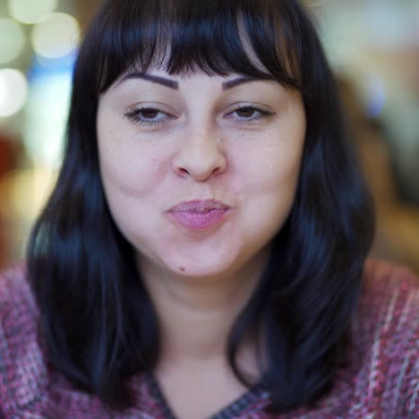 a woman eats a big burger at a fast food restaurant