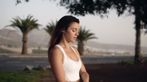 long haired woman doing muscle stretching outdoors