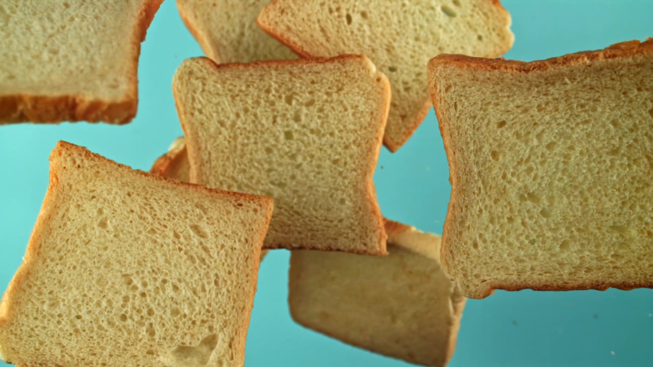 Slices of White Bread Floating on a Blue Background