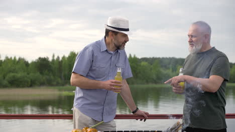 zwei ältere freunde, die ein bier trinken