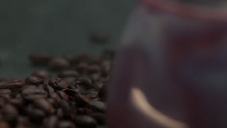 close-up macro of a smoke drifts over the coffee bean near the lila cup, mug