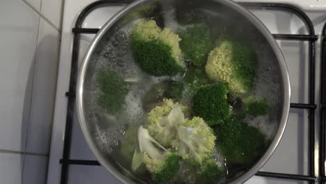 4K - Broccoli being boiled in pan - top shot