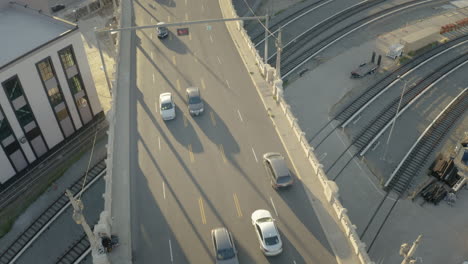 aerial view of urban bridge with traffic and train tracks
