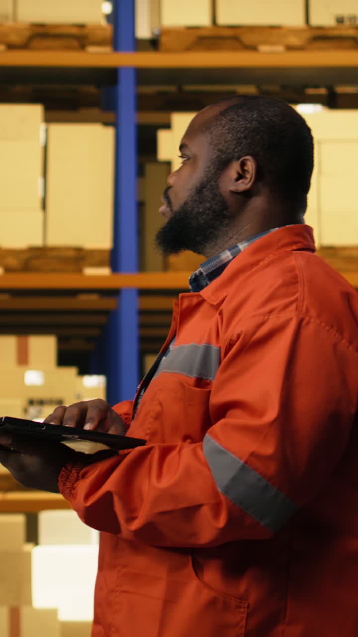Vertical Video African American Employee Using Laptop To Handle Logistics In Industrial Facility