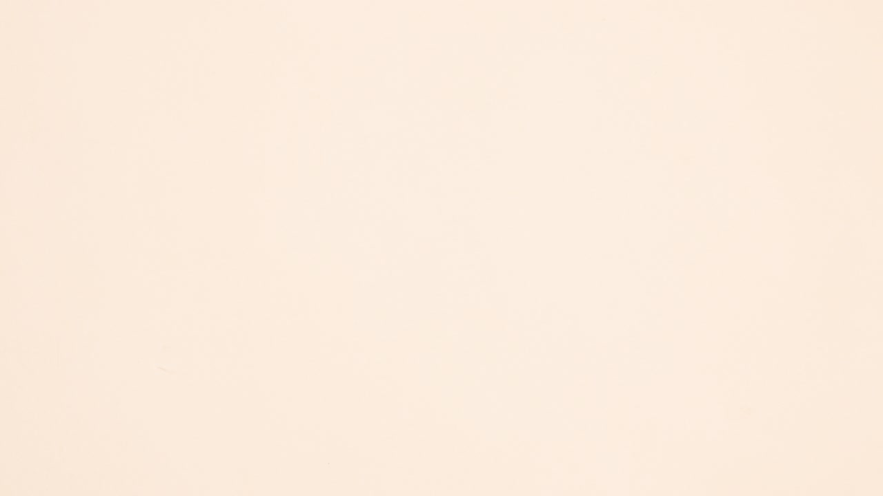 White paper for text and autumn leaves around appear on beige background. Stop motion