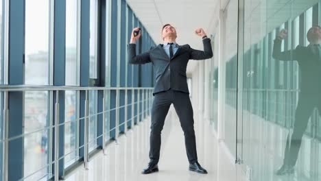 businessman in business suit dancing the dance of winners