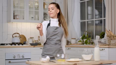 woman singing while baking in a kitchen