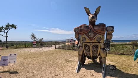 zooming out from kangaroo sculpture on beach