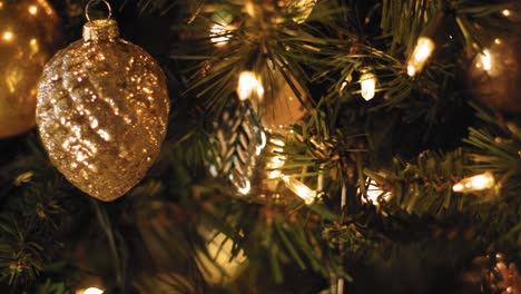 close up pan of ornaments and decorations on a christmas tree - slow motion