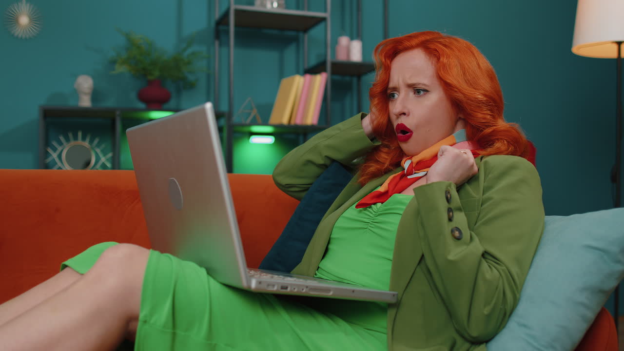 Amazed ginger girl use laptop computer, receive good news message, shocked by victory, celebrate win
