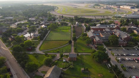 aerial view of a historical village next to a race track