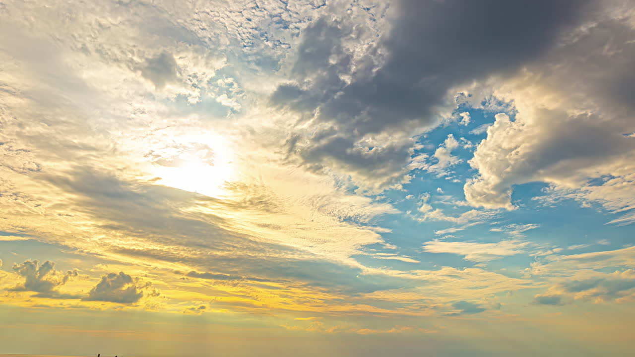 Dynamic Sky with Sunlit Clouds and Golden Hues