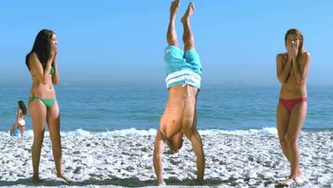 man walking on hands between two friends