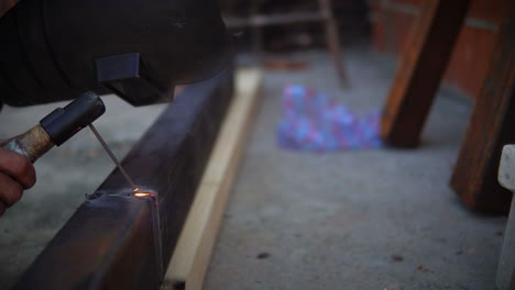 sparks from welding a metal construction pipe