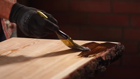 applying wood stain to a live edge table top