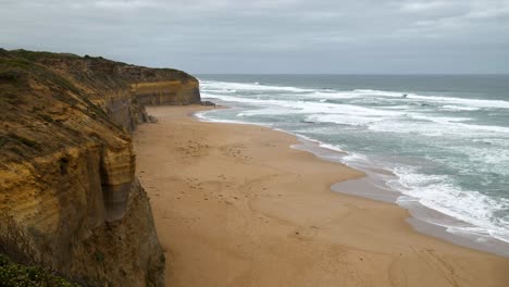 wide shot of the serene gibson step beach with its vast sandy expanse and tranquil waves