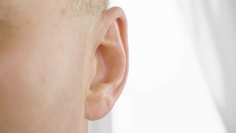 adult male ear close up. man moving his ear. otolaryngology and hearing health