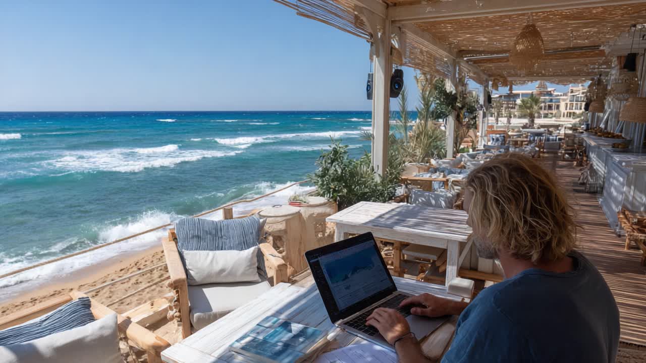 A Serene Beachside Workspace: Harnessing Productivity Amidst Ocean Waves and Scenic Views of a Sunlit Coastal Café