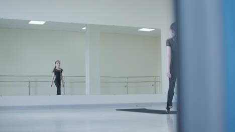 young ballerina practicing dance moves in studio