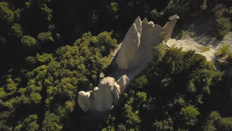 drone-shot-flying-straight-up-looking-down-on-the-pyramides-of-D'Euseigne-at-Val-D'Herens,-Switzerland-in-4k