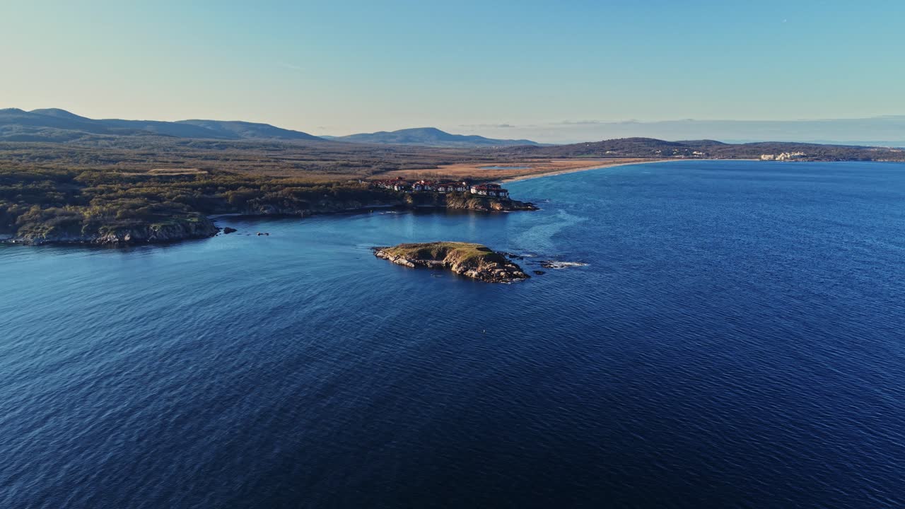 Stunning aerial view of a coastal region with lush hills and calm waters