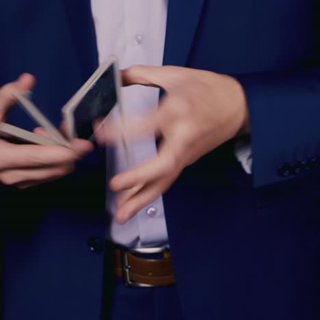 a magician cleverly shuffles a deck of playing cards 1