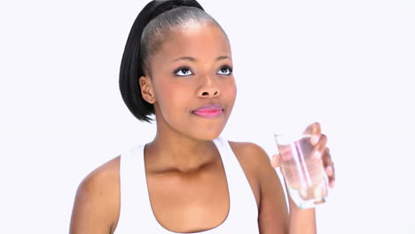 Smiling-model-in-sportswear-drinking-water