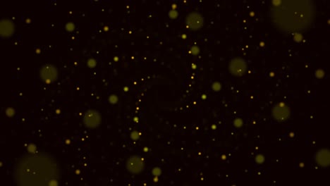 partículas de bokeh dorado sobre un fondo negro