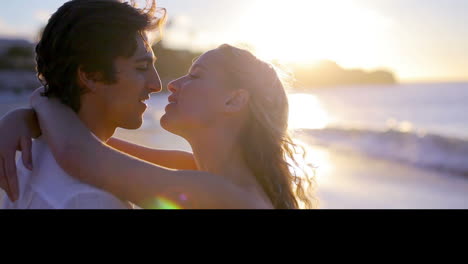 Happy-couple-kissing-each-other-on-the-beach