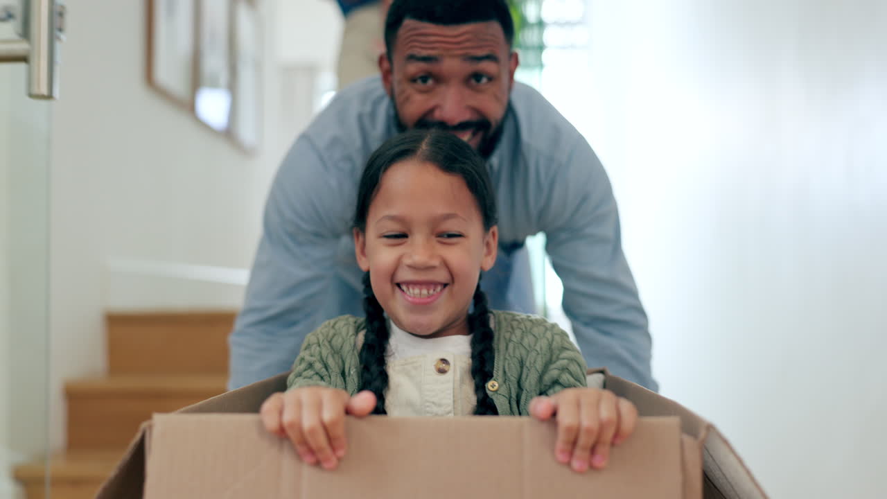 Happy family, moving in new home pushing box